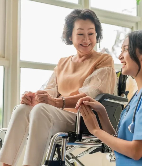 asian-young-caregiver-caring-her-elderly-patient-senior-daycare-handicap-patient-wheelchair-hospital-talking-friendly-nurse-looking-cheerful-nurse-wheeling-senior-patient_609648-3125